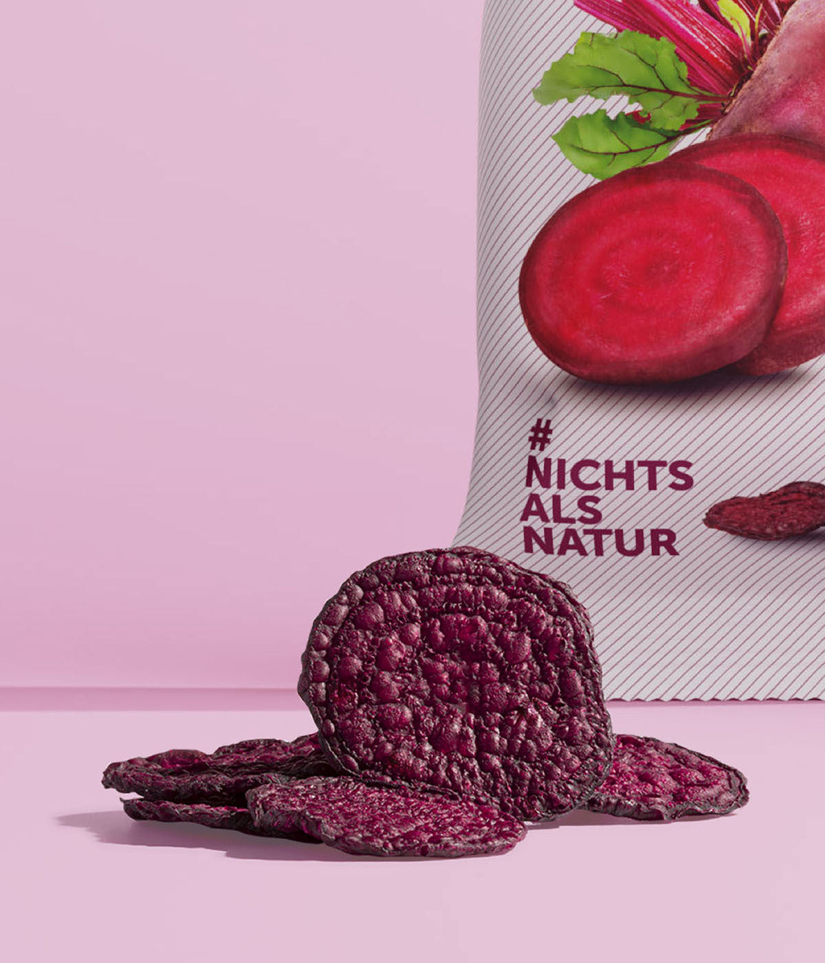 Knackige, lila, vakuumgetrocknete Rote Bete Chips von buah vor einer Packung buah Rote Bete Gemuesechips