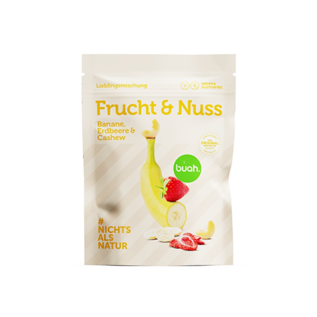 Packung buah Frucht & Nuss Mischung mit Banane, Erdbeere & Cashew vor gelbem Hintergrund